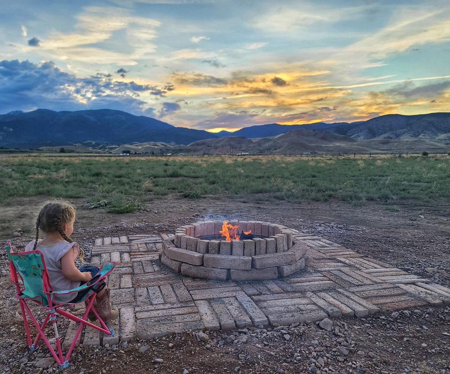 Child at fire pit watching mountain sunset at Marysvale